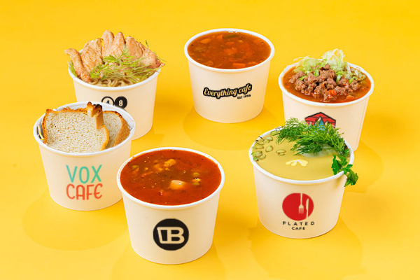 Six custom printed soup bowls in a circle, containing a variety of soups and garnishes.